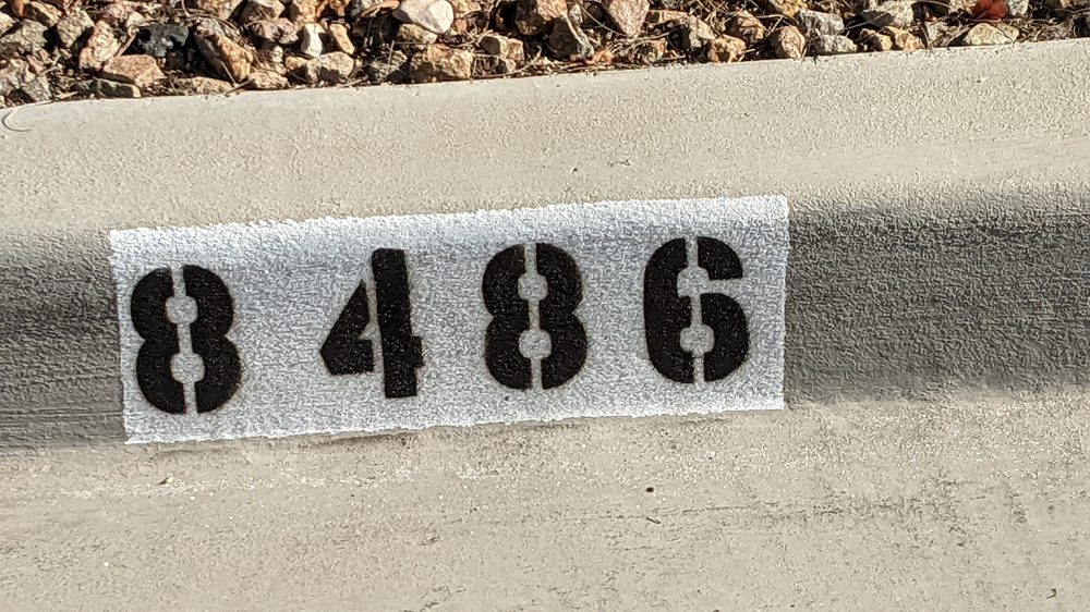 Painted curb numbers 8486