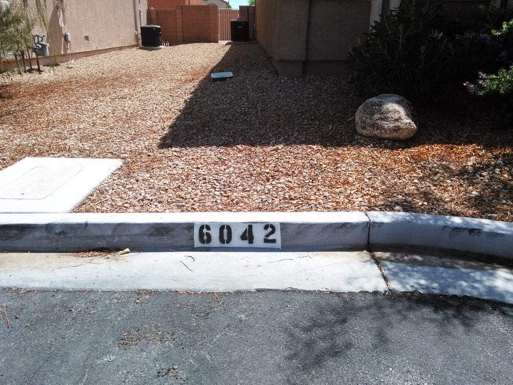 Painted curb number in front of a Las Vegas home